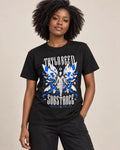 Model wearing the black Become Your Own Form graphic T-shirt, showing blue-and-white wing artwork on the front.