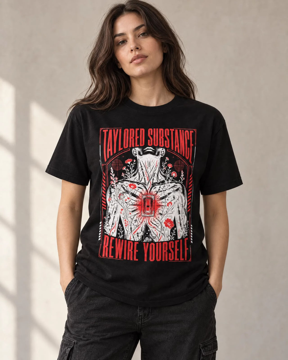 Model wearing the black Rewire Yourself graphic T-shirt with red typography and illustrated front artwork.